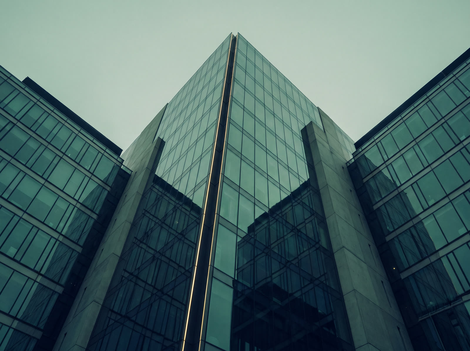 Modern glass office towers viewed from below, symbolizing business ambition